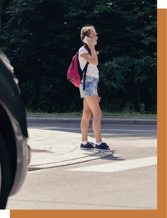 A girl pedestrian crosses the street in Burbank.