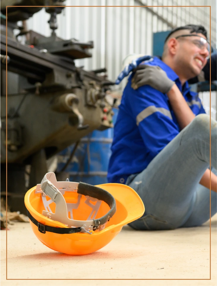Worker injured in industrial setting holding shoulder showing workplace injury case for personal injury attorney Los Angeles